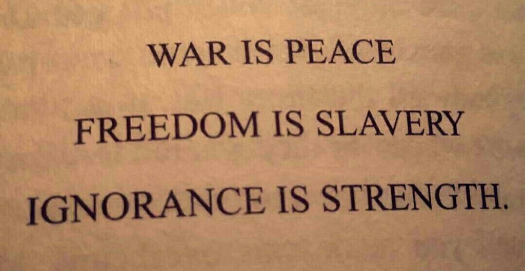 Photograph of the 1984 Party slogans: War is Peace, Freedom is Slavery, Ignorance is Strength